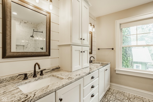 5254 N Park Ave, Indianapolis, IN 46220 - full bath featuring double vanity, plenty of natural light, tiled shower, and baseboards