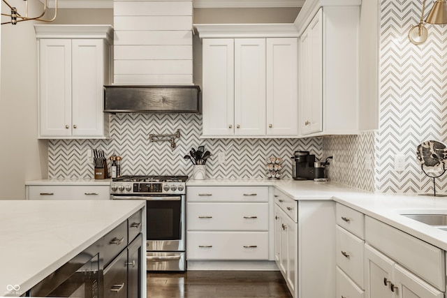 5254 N Park Ave, Indianapolis, IN 46220 - kitchen featuring stainless steel gas stove, white cabinets, decorative backsplash, and ornamental molding
