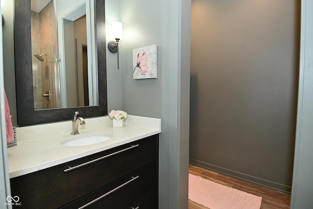 7070 Dean Rd, Indianapolis, IN 46220 - bathroom featuring vanity, wood finished floors, and baseboards