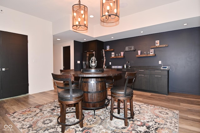 7070 Dean Rd, Indianapolis, IN 46220 - indoor wet bar with stainless steel refrigerator with ice dispenser, light wood-style flooring, and pendant lighting