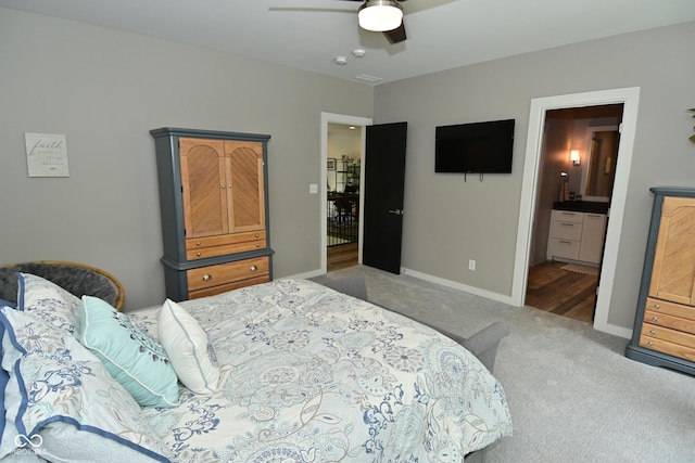7070 Dean Rd, Indianapolis, IN 46220 - carpeted bedroom with baseboards, ceiling fan, and ensuite bathroom