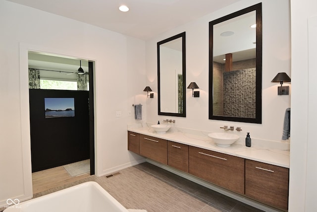 7070 Dean Rd, Indianapolis, IN 46220 - bathroom featuring double vanity, tiled shower, recessed lighting, a ceiling fan, and baseboards