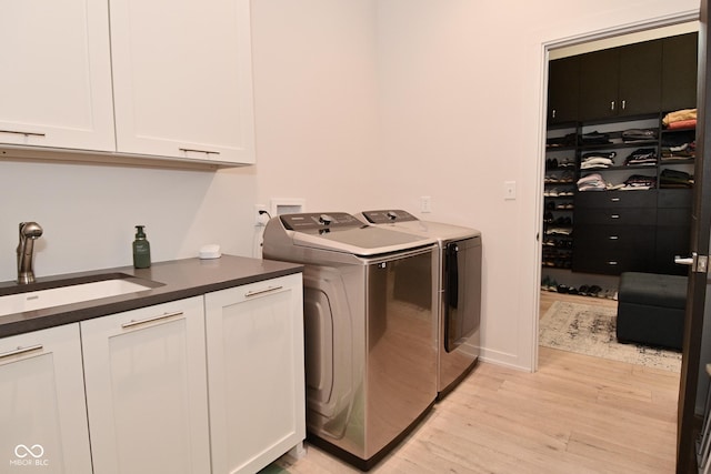 7070 Dean Rd, Indianapolis, IN 46220 - washroom with cabinet space, washing machine and dryer, and light wood-type flooring