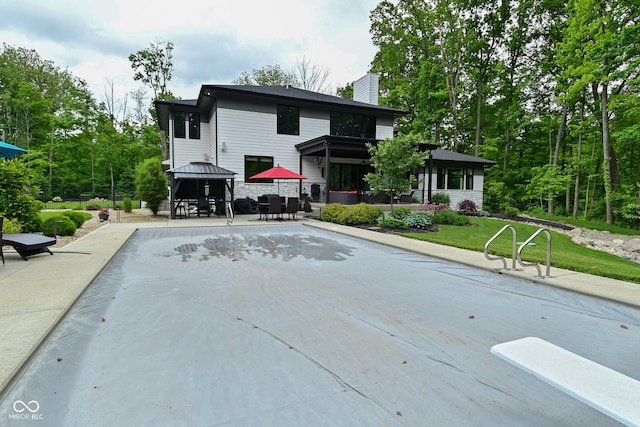 7070 Dean Rd, Indianapolis, IN 46220 - rear view of house featuring a gazebo, a chimney, and outdoor dining area