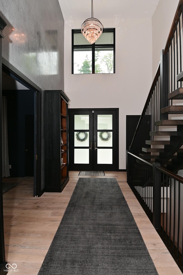7070 Dean Rd, Indianapolis, IN 46220 - entrance foyer with a chandelier, a high ceiling, french doors, wood finished floors, and stairs