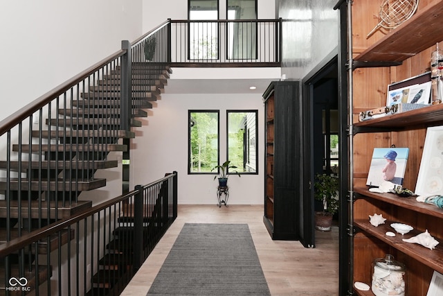 7070 Dean Rd, Indianapolis, IN 46220 - stairs featuring wood finished floors, baseboards, and a high ceiling