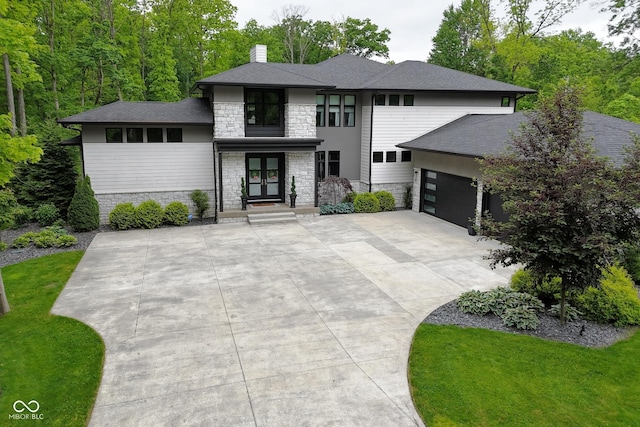 7070 Dean Rd, Indianapolis, IN 46220 - prairie-style home featuring stone siding, french doors, a garage, a chimney, and concrete driveway