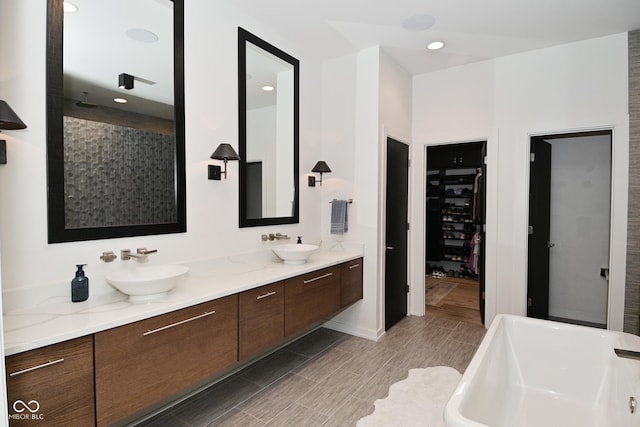 7070 Dean Rd, Indianapolis, IN 46220 - full bathroom featuring a soaking tub, double vanity, tiled shower, wood tiled floors, and recessed lighting