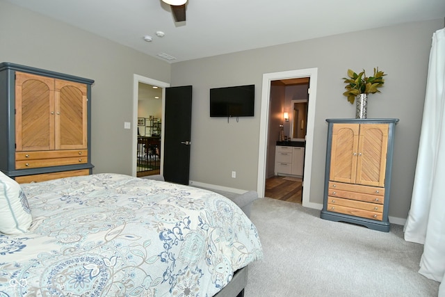 7070 Dean Rd, Indianapolis, IN 46220 - carpeted bedroom featuring baseboards, connected bathroom, and ceiling fan
