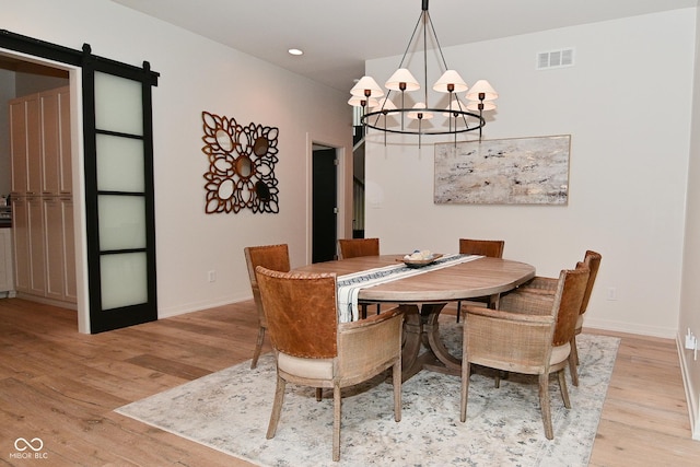 7070 Dean Rd, Indianapolis, IN 46220 - dining room with a chandelier, light wood-style flooring, a barn door, baseboards, and recessed lighting