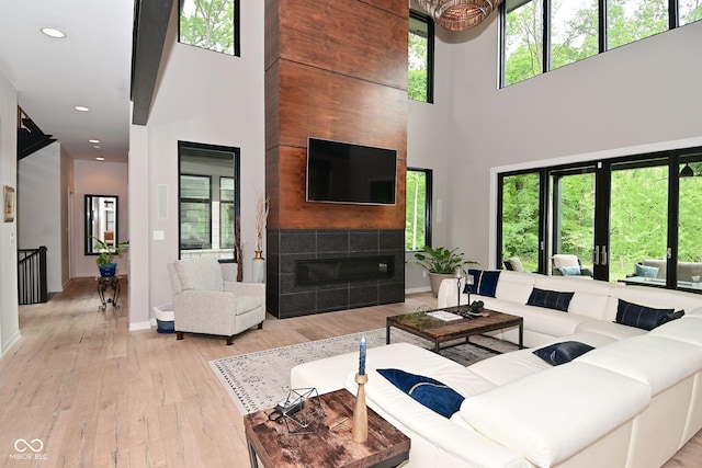 7070 Dean Rd, Indianapolis, IN 46220 - living area with a towering ceiling, a fireplace, hardwood / wood-style floors, baseboards, and recessed lighting