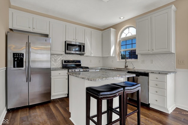 7637 Sand Run Ct, Indianapolis, IN 46259 - kitchen featuring appliances with stainless steel finishes, dark wood finished floors, white cabinets, light stone counters, and recessed lighting