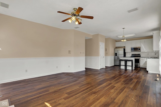 7637 Sand Run Ct, Indianapolis, IN 46259 - unfurnished living room featuring ceiling fan, dark wood finished floors, a sink, and wainscoting
