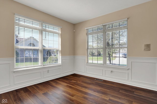 7637 Sand Run Ct, Indianapolis, IN 46259 - empty room with wainscoting, dark wood-style flooring, and a decorative wall