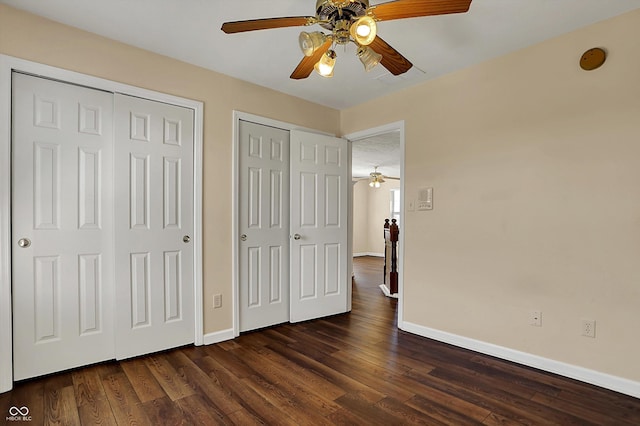 7637 Sand Run Ct, Indianapolis, IN 46259 - unfurnished bedroom featuring baseboards, multiple closets, dark wood-style flooring, and ceiling fan