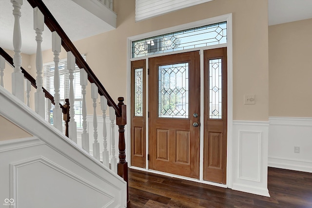 7637 Sand Run Ct, Indianapolis, IN 46259 - entrance foyer featuring plenty of natural light, a wainscoted wall, dark wood finished floors, and stairway
