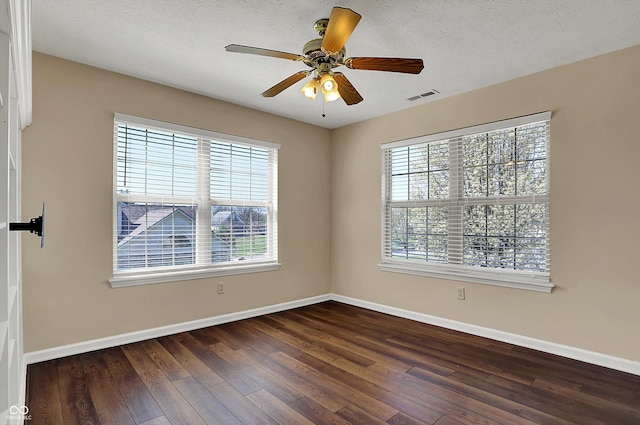 7637 Sand Run Ct, Indianapolis, IN 46259 - empty room with baseboards, dark wood-style floors, a ceiling fan, and a textured ceiling