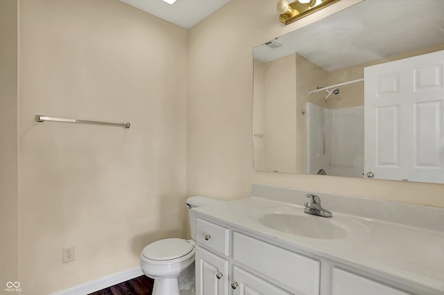 7637 Sand Run Ct, Indianapolis, IN 46259 - full bathroom featuring toilet, vanity, a shower, baseboards, and wood finished floors