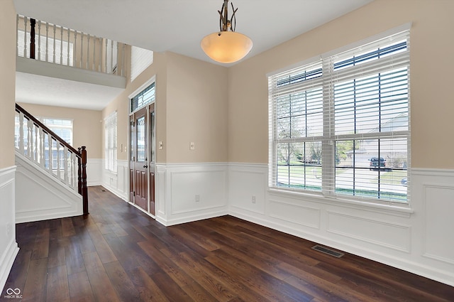 7637 Sand Run Ct, Indianapolis, IN 46259 - entryway featuring wainscoting, dark wood finished floors, stairway, and a decorative wall