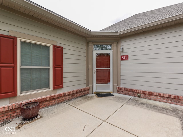 811 Gazebo Way, Greenwood, IN 46142 - property entrance with brick siding, a patio, and a shingled roof
