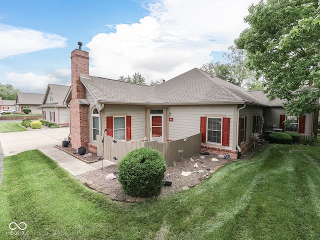 811 Gazebo Way, Greenwood, IN 46142 - back of house with roof with shingles, a yard, a chimney, driveway, and brick siding
