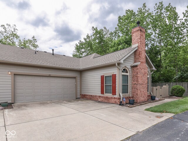 811 Gazebo Way, Greenwood, IN 46142 - ranch-style home featuring brick siding, concrete driveway, a chimney, an attached garage, and roof with shingles