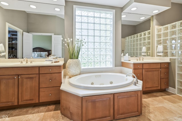 16502 Grand Cypress Dr, Noblesville, IN 46060 - bathroom with a whirlpool tub, two vanities, and ensuite bath