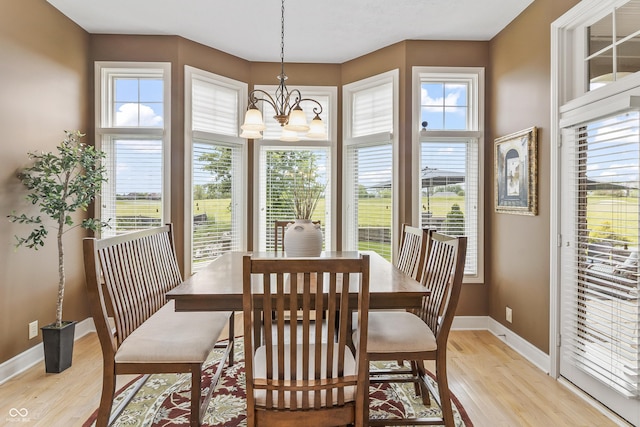 16502 Grand Cypress Dr, Noblesville, IN 46060 - dining space with light wood-type flooring, baseboards, and a chandelier