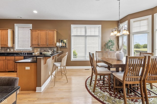 16502 Grand Cypress Dr, Noblesville, IN 46060 - dining space featuring baseboards, light wood-style flooring, a chandelier, and recessed lighting