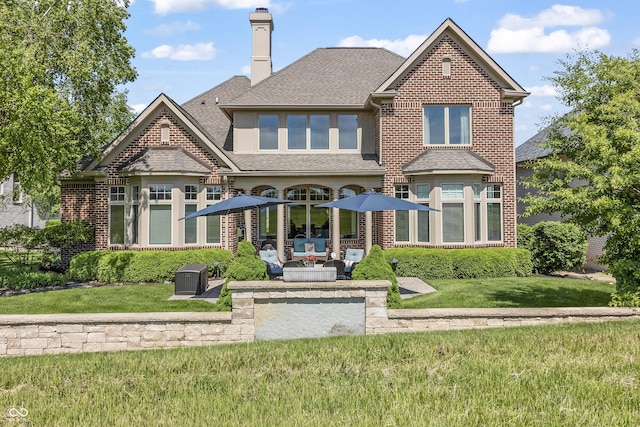 16502 Grand Cypress Dr, Noblesville, IN 46060 - rear view of house featuring a patio area, a chimney, a lawn, and a shingled roof