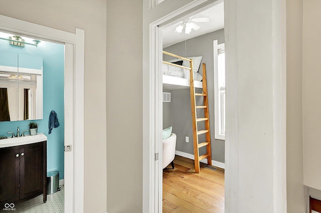 514 Dorman St, Indianapolis, IN 46202 - hall with light wood-style flooring, a sink, and baseboards