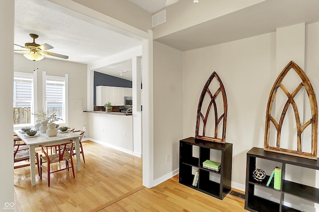 514 Dorman St, Indianapolis, IN 46202 - dining room with a ceiling fan, light wood-style floors, and baseboards