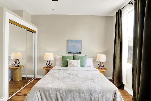 514 Dorman St, Indianapolis, IN 46202 - bedroom with a closet, wood finished floors, and baseboards