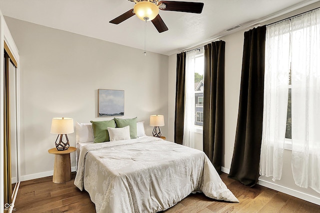 514 Dorman St, Indianapolis, IN 46202 - bedroom featuring baseboards, wood finished floors, and a ceiling fan