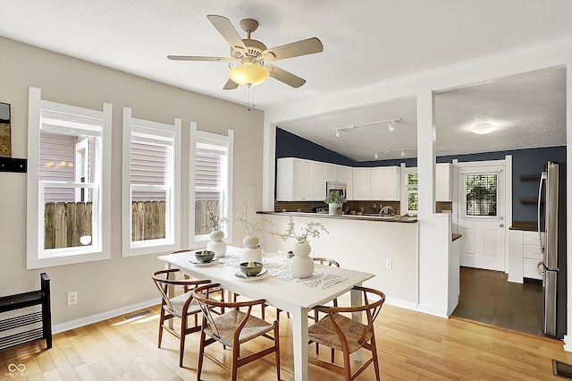 514 Dorman St, Indianapolis, IN 46202 - dining area with lofted ceiling, light wood finished floors, ceiling fan, a textured ceiling, and rail lighting