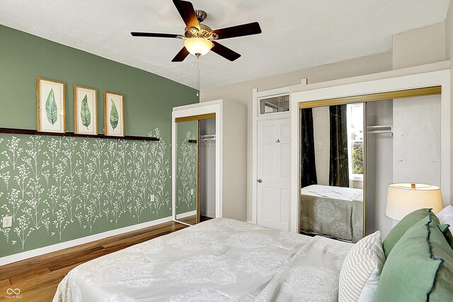 514 Dorman St, Indianapolis, IN 46202 - bedroom featuring two closets, wood finished floors, baseboards, and a ceiling fan