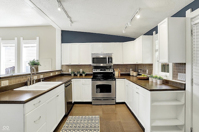 514 Dorman St, Indianapolis, IN 46202 - kitchen with appliances with stainless steel finishes, a sink, dark countertops, rail lighting, and a textured ceiling