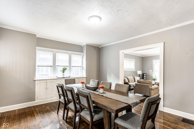 4409 N College Ave, Indianapolis, IN 46205 - dining area featuring dark wood-style floors, crown molding, a textured ceiling, and baseboards