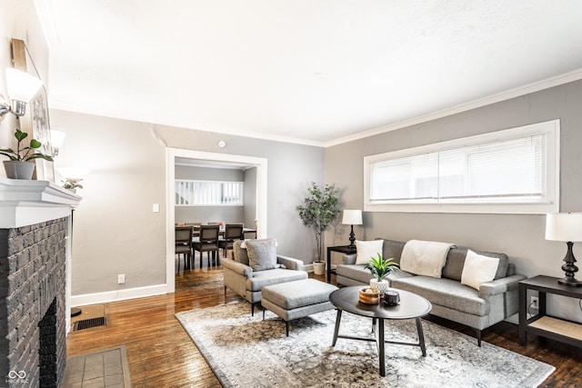 4409 N College Ave, Indianapolis, IN 46205 - living area featuring a brick fireplace, healthy amount of natural light, wood finished floors, crown molding, and baseboards