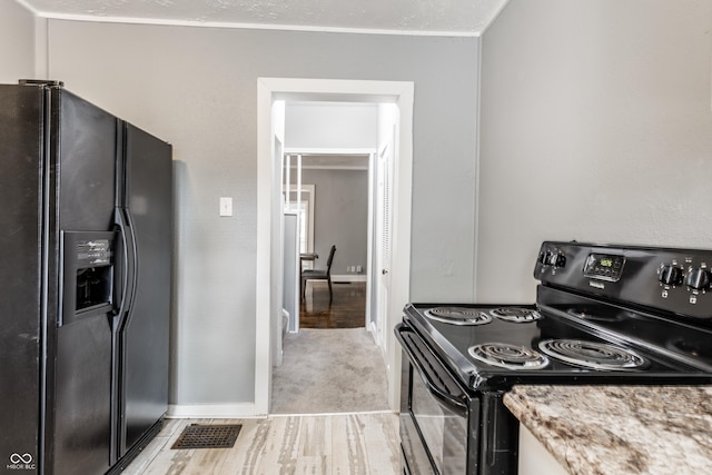 4409 N College Ave, Indianapolis, IN 46205 - kitchen featuring black appliances, light stone counters, baseboards, and light wood-type flooring