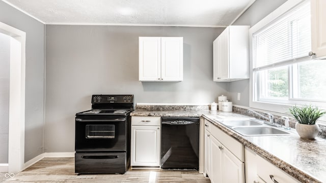 4409 N College Ave, Indianapolis, IN 46205 - kitchen with black appliances, a sink, light wood-style floors, white cabinetry, and a textured ceiling