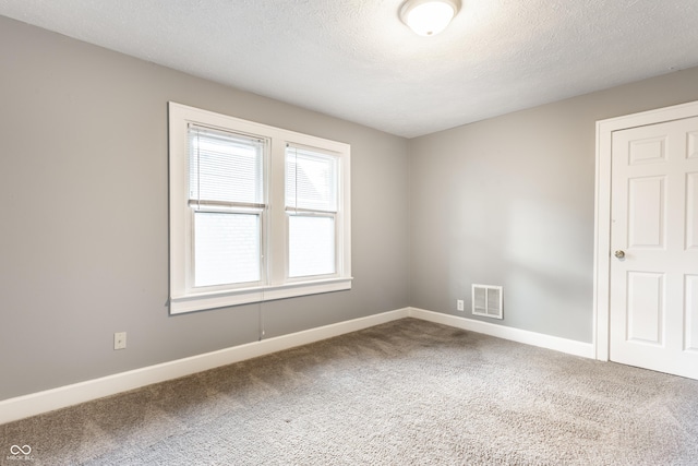 4409 N College Ave, Indianapolis, IN 46205 - empty room with carpet, baseboards, and a textured ceiling