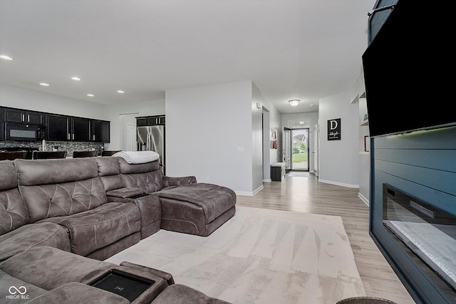 7724 Dunleer Dr, Brownsburg, IN 46112 - living room featuring light wood finished floors, baseboards, and recessed lighting