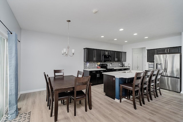 7724 Dunleer Dr, Brownsburg, IN 46112 - dining space with light wood-style flooring, a chandelier, recessed lighting, and baseboards