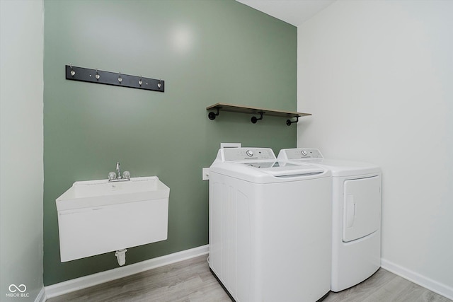 7724 Dunleer Dr, Brownsburg, IN 46112 - washroom with washer and clothes dryer, light wood-style floors, and baseboards