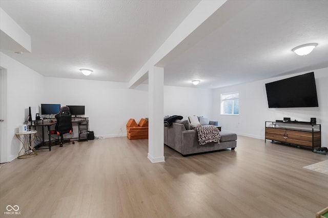 7724 Dunleer Dr, Brownsburg, IN 46112 - living area featuring light wood-style flooring, a desk, and baseboards