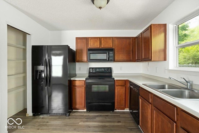 11821 Wapiti Way, Noblesville, IN 46060 - kitchen with black appliances, a sink, dark wood-style floors, light countertops, and a textured ceiling