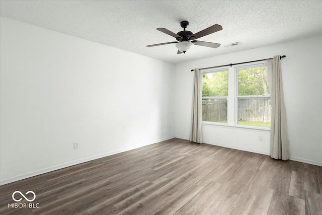 11821 Wapiti Way, Noblesville, IN 46060 - spare room with wood finished floors, a textured ceiling, a ceiling fan, and baseboards