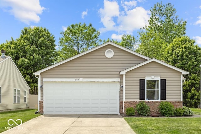 11821 Wapiti Way, Noblesville, IN 46060 - view of front of property with brick siding, concrete driveway, an attached garage, and a front lawn