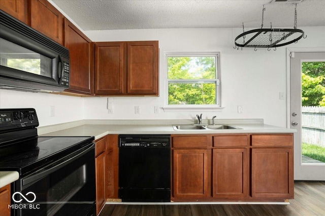 11821 Wapiti Way, Noblesville, IN 46060 - kitchen featuring black appliances, a sink, dark wood-type flooring, and light countertops